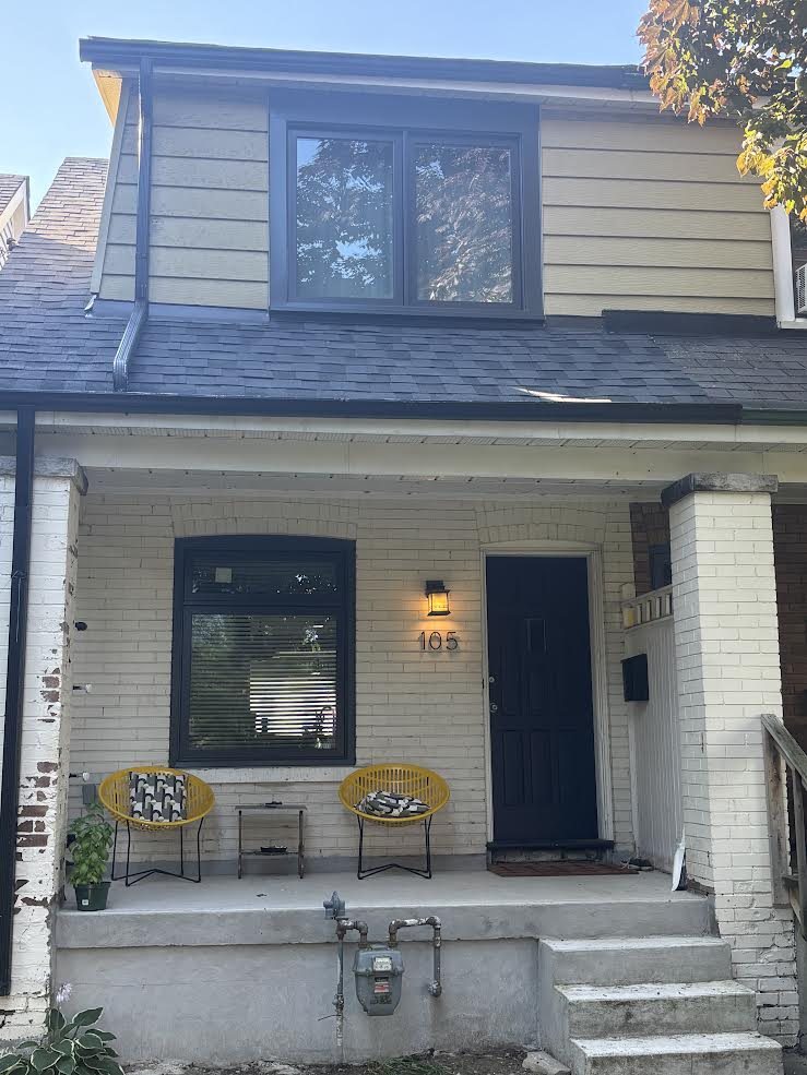 Real WDC project: black-frame windows and black entry door on a brick porch home